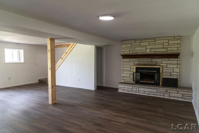 1443 N Posey Lake Rd, Hudson, MI 49247 - unfurnished living room featuring wood finished floors, a fireplace, and baseboards