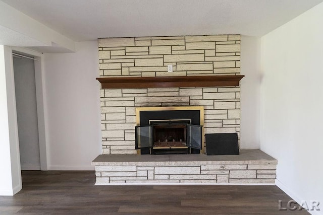 1443 N Posey Lake Rd, Hudson, MI 49247 - detailed view of a stone fireplace, baseboards, and wood finished floors