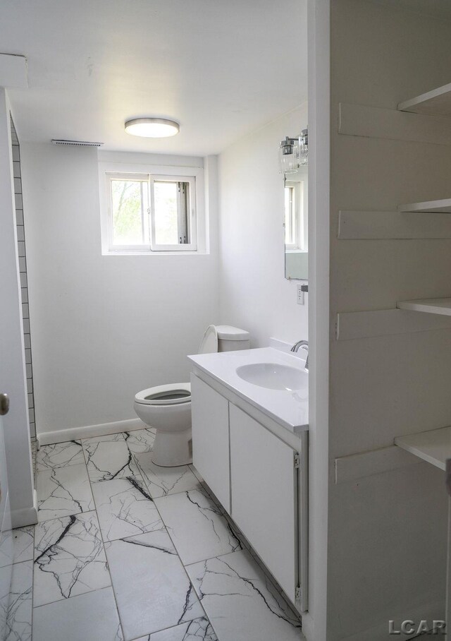 1443 N Posey Lake Rd, Hudson, MI 49247 - bathroom with vanity, marble finish floors, toilet, and baseboards