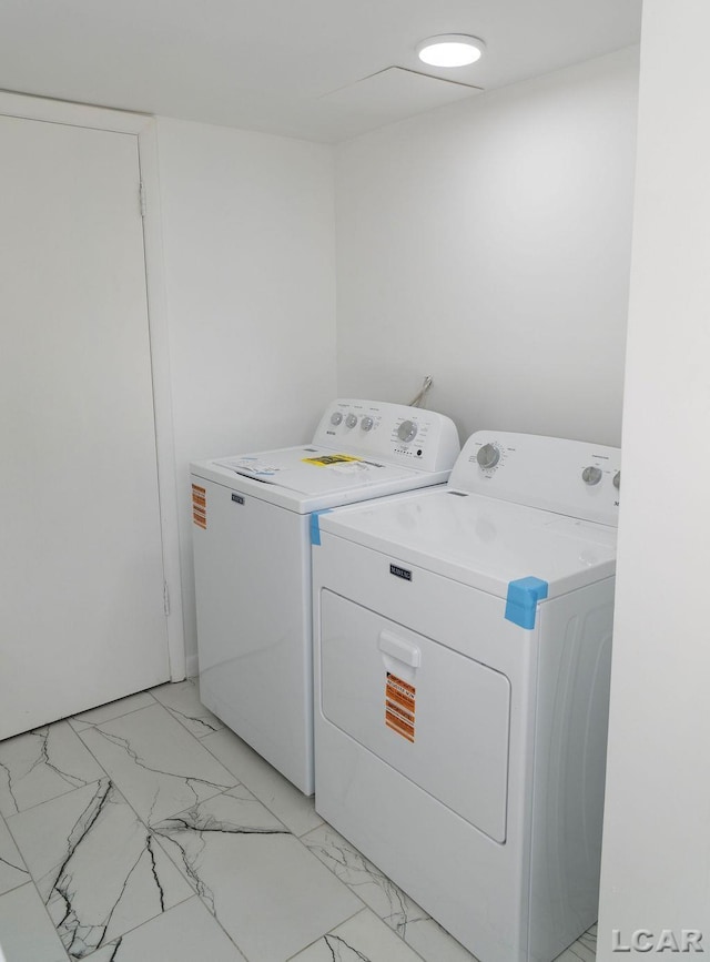 1443 N Posey Lake Rd, Hudson, MI 49247 - laundry area with washer and dryer and light marble finish floors