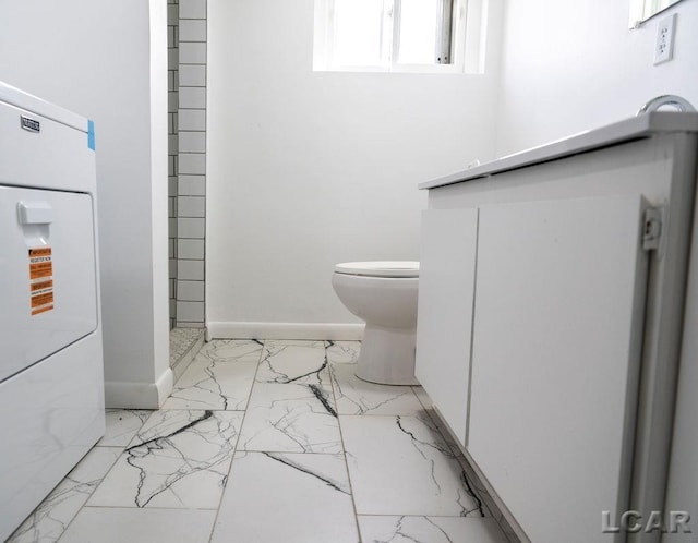1443 N Posey Lake Rd, Hudson, MI 49247 - bathroom featuring marble finish floors, toilet, washer / clothes dryer, and baseboards