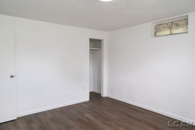 1443 N Posey Lake Rd, Hudson, MI 49247 - unfurnished bedroom featuring wood finished floors, baseboards, and a closet