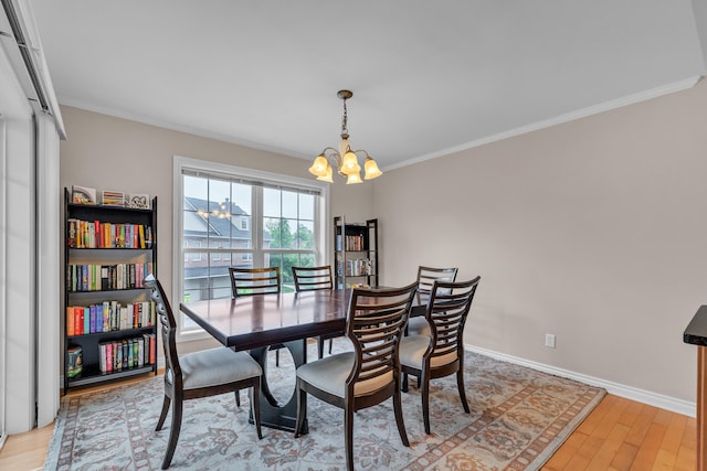 3366 Endsleigh Ln, Ypsilanti, MI 48197 - dining room featuring a chandelier, ornamental molding, light wood finished floors, and baseboards