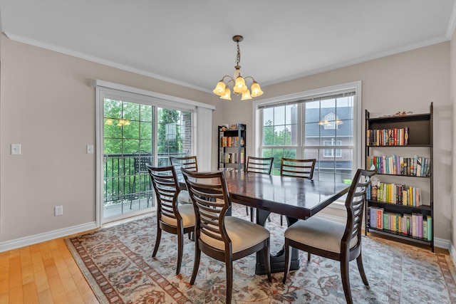 3366 Endsleigh Ln, Ypsilanti, MI 48197 - dining space with a chandelier, ornamental molding, baseboards, and wood finished floors