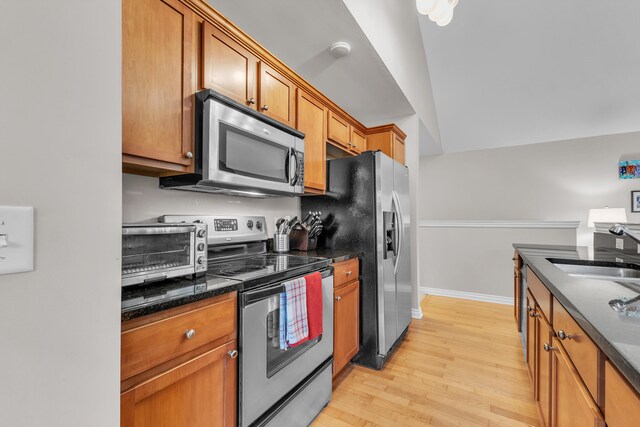 3366 Endsleigh Ln, Ypsilanti, MI 48197 - kitchen featuring appliances with stainless steel finishes, a sink, light wood finished floors, and brown cabinetry
