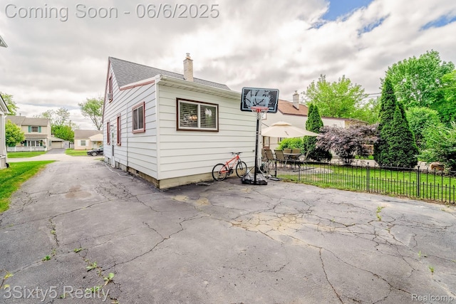 3831 Durham Rd, Royal Oak, MI 48073 - rear view of house with a chimney, a patio area, and a shingled roof