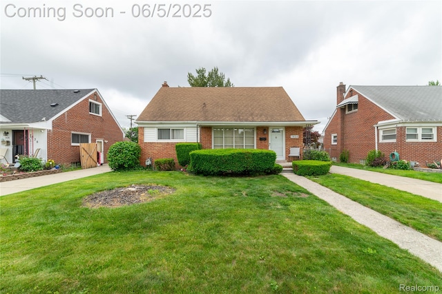7620 Polk St, Southgate, MI 48180 - view of front facade featuring brick siding and a front lawn