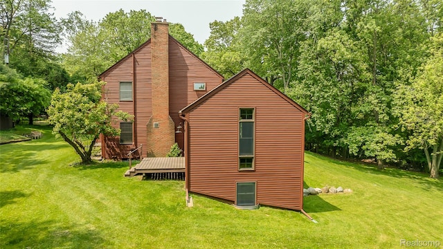 2694 Wayside Dr, Ann Arbor, MI 48103 - rear view of property featuring a chimney, a lawn, a wooden deck, and view of scattered trees