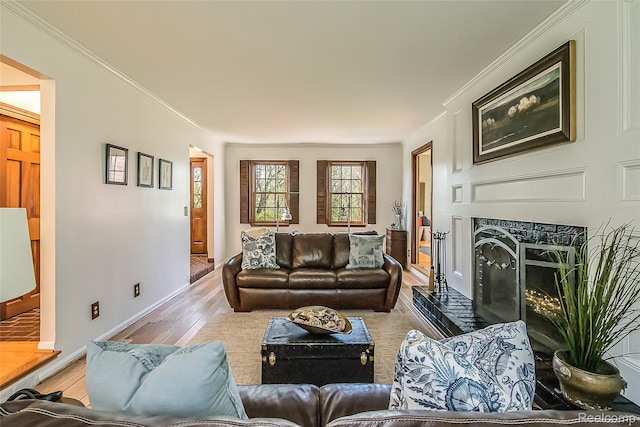 2694 Wayside Dr, Ann Arbor, MI 48103 - living area featuring a fireplace with raised hearth, wood finished floors, crown molding, and baseboards