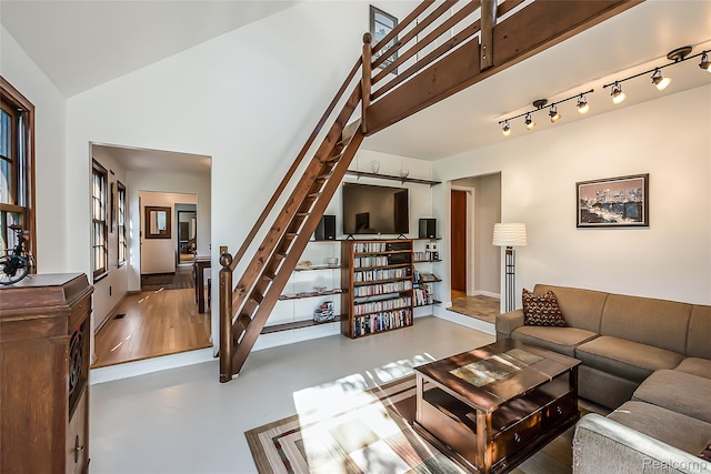 2694 Wayside Dr, Ann Arbor, MI 48103 - living room featuring stairway, high vaulted ceiling, and baseboards