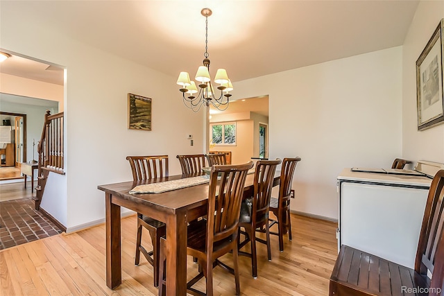 2694 Wayside Dr, Ann Arbor, MI 48103 - dining room with a chandelier, light wood-style floors, and baseboards