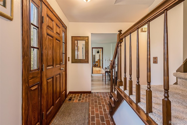 2694 Wayside Dr, Ann Arbor, MI 48103 - foyer featuring stairs, brick floors, and baseboards