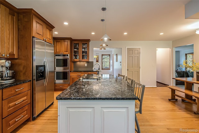 2694 Wayside Dr, Ann Arbor, MI 48103 - kitchen featuring stainless steel appliances, a sink, brown cabinetry, light wood-style flooring, and recessed lighting