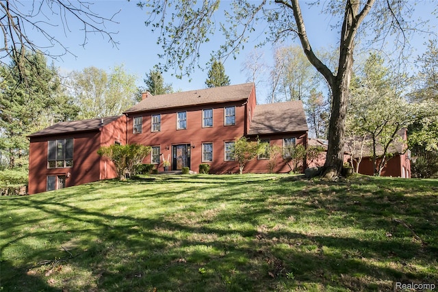 2694 Wayside Dr, Ann Arbor, MI 48103 - back of property featuring a chimney and a yard