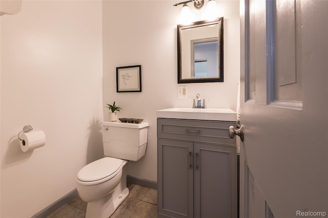 2694 Wayside Dr, Ann Arbor, MI 48103 - half bathroom with toilet, vanity, baseboards, and tile patterned floors