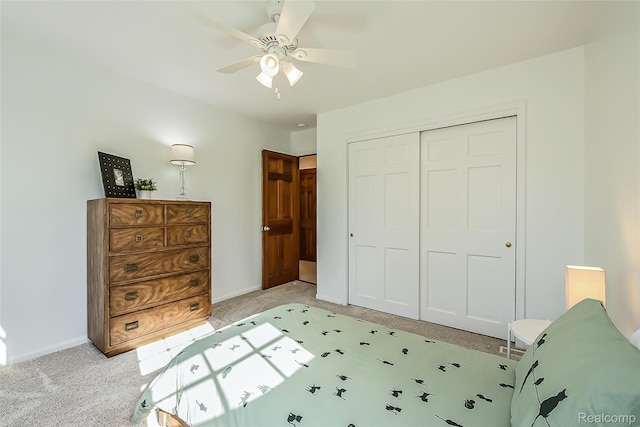 2694 Wayside Dr, Ann Arbor, MI 48103 - bedroom with light carpet, a closet, baseboards, and a ceiling fan