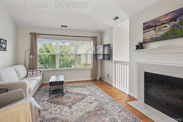 1637 Coburn Dr, Ann Arbor, MI 48108 - living area featuring wood finished floors and a tile fireplace