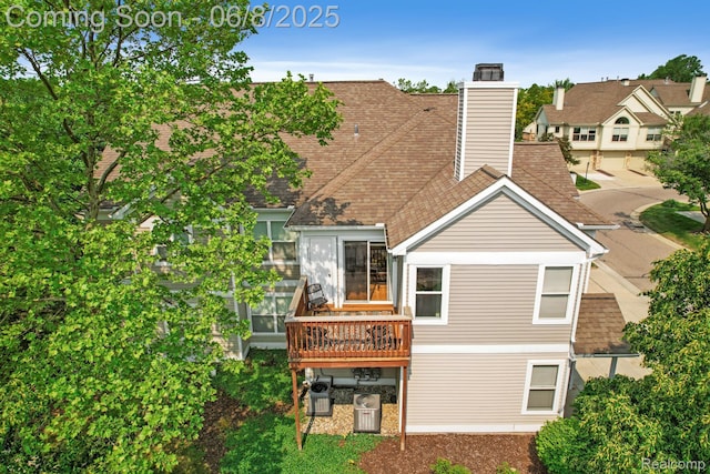1637 Coburn Dr, Ann Arbor, MI 48108 - back of property with a chimney and roof with shingles