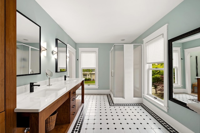 903 Lake Blvd, Saint Joseph, MI 49085 - bathroom with baseboards, a stall shower, double vanity, and tile patterned floors