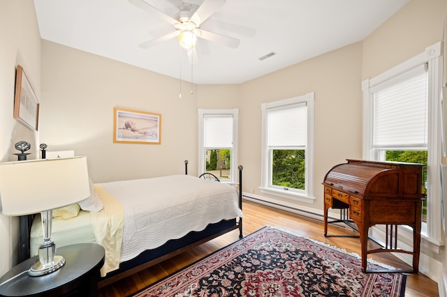 903 Lake Blvd, Saint Joseph, MI 49085 - bedroom featuring multiple windows, light wood finished floors, and baseboard heating