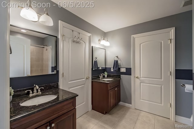 8922 Stonewall W, Clarkston, MI 48348 - bathroom featuring tile patterned floors, two vanities, baseboards, and a shower
