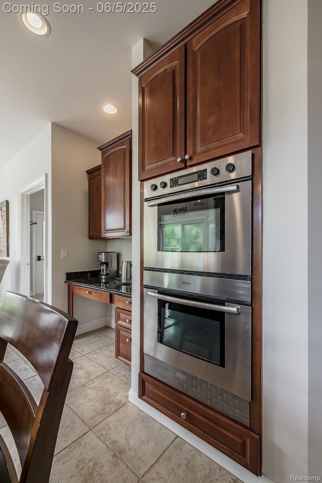 8922 Stonewall W, Clarkston, MI 48348 - kitchen featuring double oven, dark countertops, light tile patterned floors, and recessed lighting