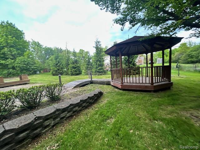 6880 Burtonwood Dr, West Bloomfield, MI 48322 - view of grassy yard with a gazebo and a wooden deck