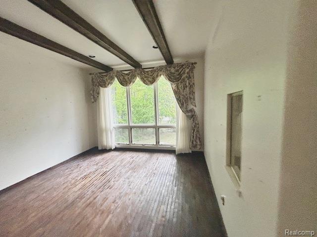 6880 Burtonwood Dr, West Bloomfield, MI 48322 - spare room with beam ceiling and wood finished floors