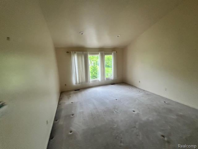6880 Burtonwood Dr, West Bloomfield, MI 48322 - spare room featuring vaulted ceiling