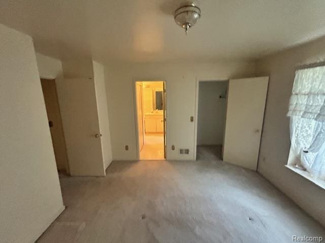 6880 Burtonwood Dr, West Bloomfield, MI 48322 - unfurnished bedroom with carpet flooring, a closet, and connected bathroom
