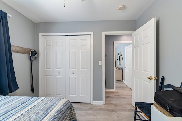 11815 Waldron Rd, Jerome, MI 49249 - bedroom featuring light wood-style floors, a closet, and baseboards