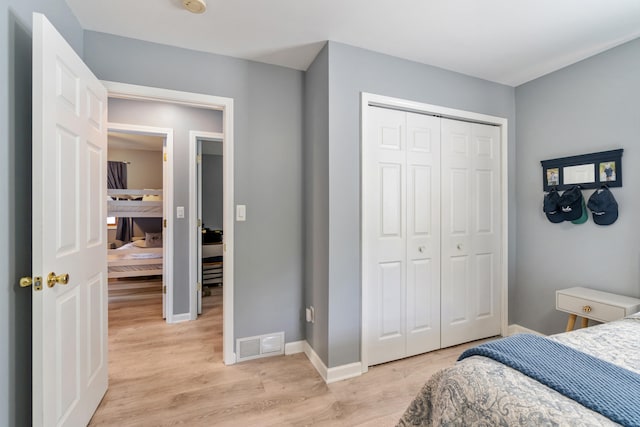 11815 Waldron Rd, Jerome, MI 49249 - bedroom featuring light wood-style floors, a closet, and baseboards
