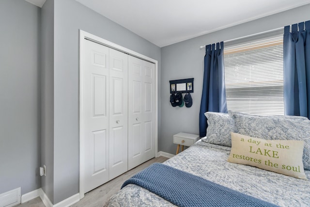 11815 Waldron Rd, Jerome, MI 49249 - bedroom with a closet, baseboards, and wood finished floors