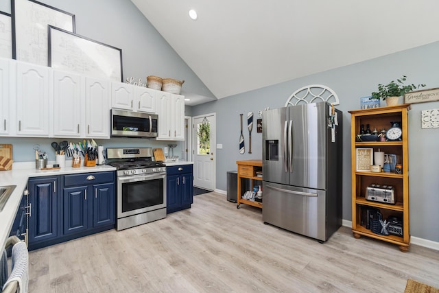 11815 Waldron Rd, Jerome, MI 49249 - kitchen with appliances with stainless steel finishes, blue cabinetry, white cabinets, light countertops, and high vaulted ceiling