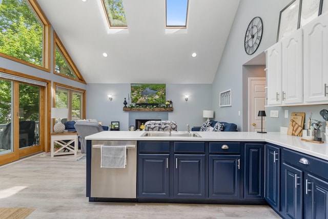 11815 Waldron Rd, Jerome, MI 49249 - kitchen with stainless steel dishwasher, open floor plan, high vaulted ceiling, blue cabinetry, and a sink