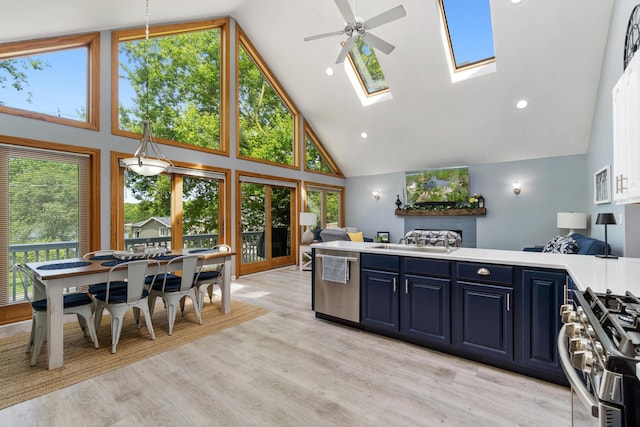 11815 Waldron Rd, Jerome, MI 49249 - kitchen with appliances with stainless steel finishes, high vaulted ceiling, blue cabinets, a peninsula, and ceiling fan