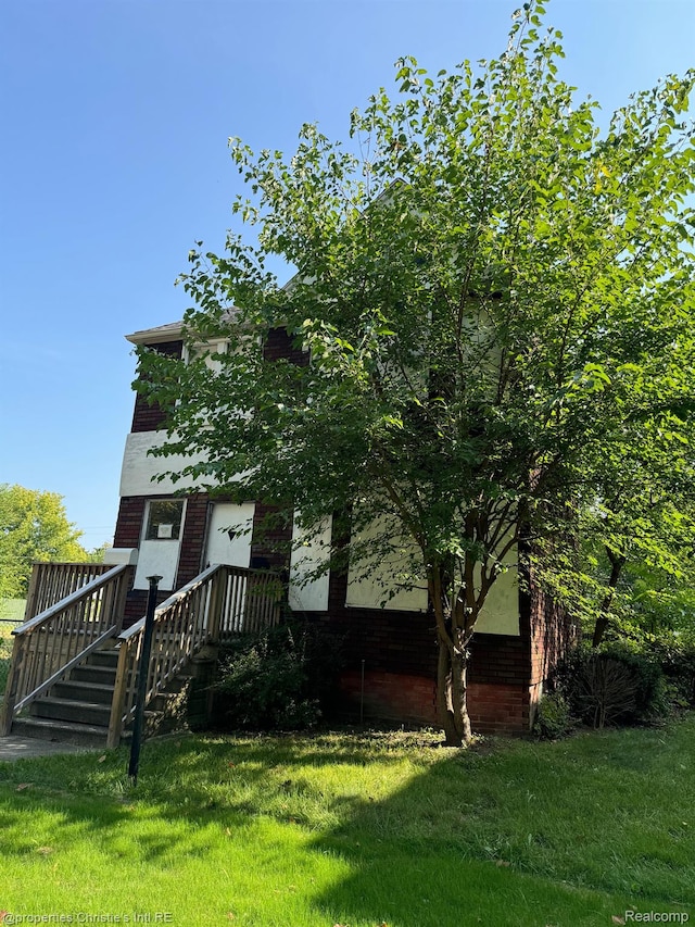 2986 Cadillac Blvd, Detroit, MI 48214 - view of property hidden behind natural elements with a front lawn and brick siding