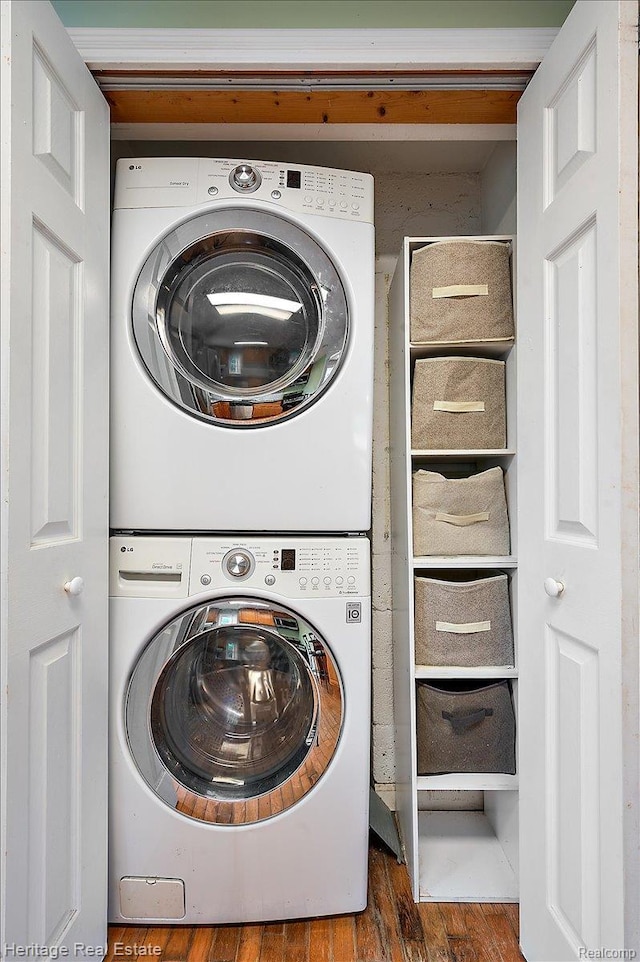 5125 Clarkston Rd, Clarkston, MI 48348 - washroom featuring stacked washer / drying machine and wood finished floors