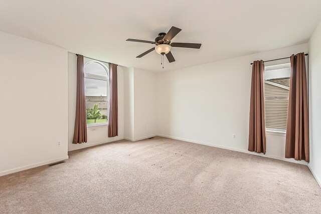 6837 Wellington Dr, Dexter, MI 48130 - unfurnished room with a ceiling fan, light colored carpet, and baseboards