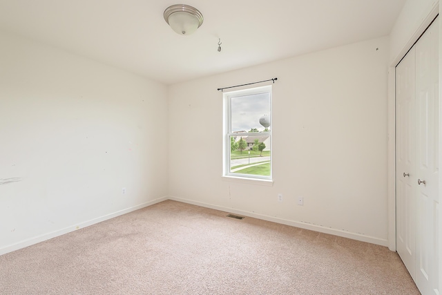 6837 Wellington Dr, Dexter, MI 48130 - unfurnished bedroom with a closet, light colored carpet, and baseboards