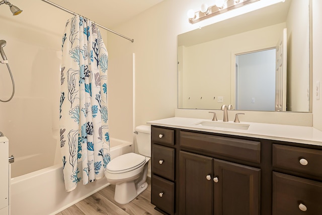 6837 Wellington Dr, Dexter, MI 48130 - full bath with shower / bath combo with shower curtain, vanity, toilet, and wood finished floors