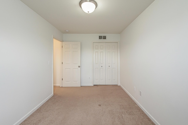 6837 Wellington Dr, Dexter, MI 48130 - unfurnished bedroom featuring baseboards, light colored carpet, and a closet