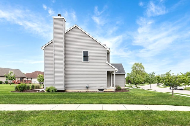 6837 Wellington Dr, Dexter, MI 48130 - view of home's exterior featuring a lawn and a chimney