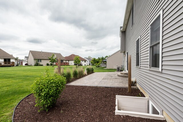 6837 Wellington Dr, Dexter, MI 48130 - view of green lawn featuring a patio area, a residential view, and central AC unit