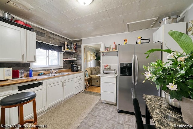 23733 Champaign St, Taylor, MI 48180 - kitchen featuring stainless steel fridge with ice dispenser, a sink, white cabinetry, open shelves, and ornamental molding