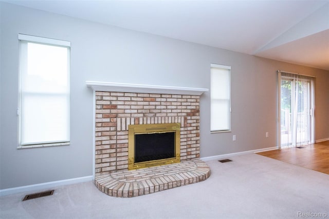 53395 Andrew Cir, New Baltimore, MI 48047 - unfurnished living room with a fireplace, carpet flooring, baseboards, and vaulted ceiling