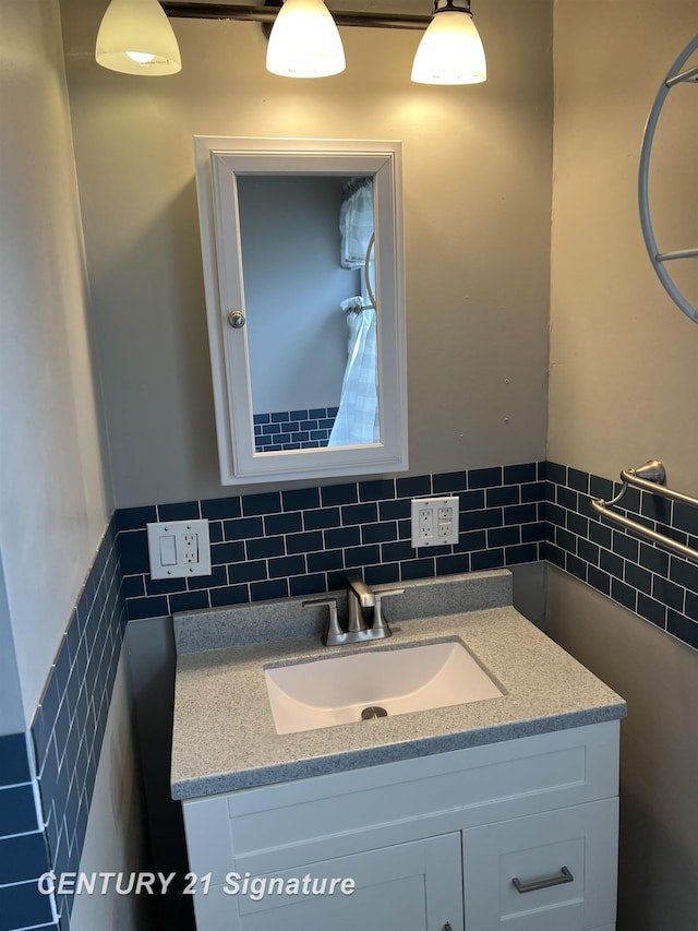 2080 E Schumacher St, Burton, MI 48529 - bathroom featuring vanity, tile walls, and a wainscoted wall