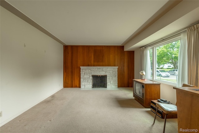2812 Berkley St, Flint, MI 48504 - carpeted living area with wood walls and a stone fireplace