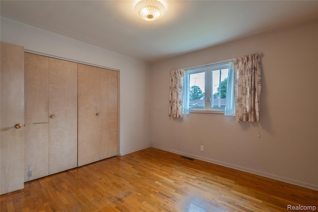 2812 Berkley St, Flint, MI 48504 - unfurnished bedroom featuring wood-type flooring and a closet