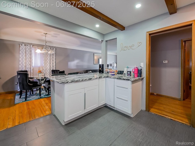 13973 Dixie, Redford, MI 48239 - kitchen with beam ceiling, light stone counters, white cabinetry, a peninsula, and hanging light fixtures